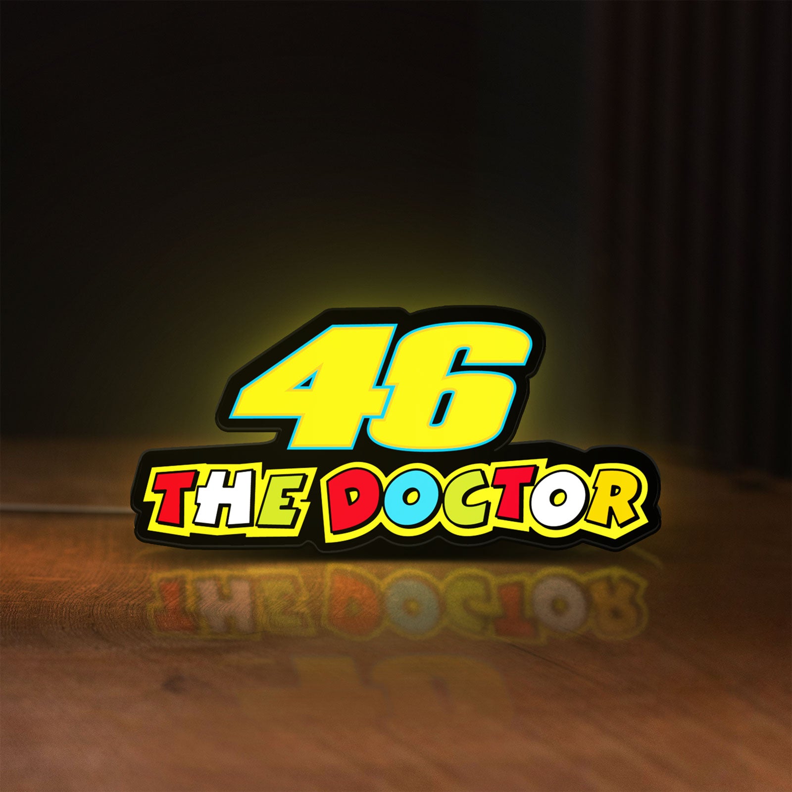 Front view of 46 The Doctor LED lightbox sign glowing on a wooden desk