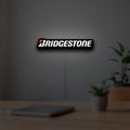 Bridgestone LED lightbox hanging on a room wall with soft white light