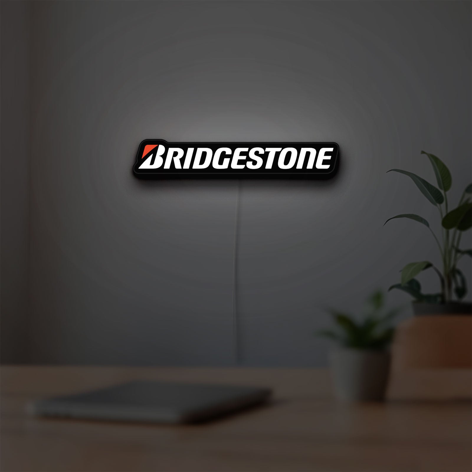 Bridgestone LED lightbox hanging on a room wall with soft white light