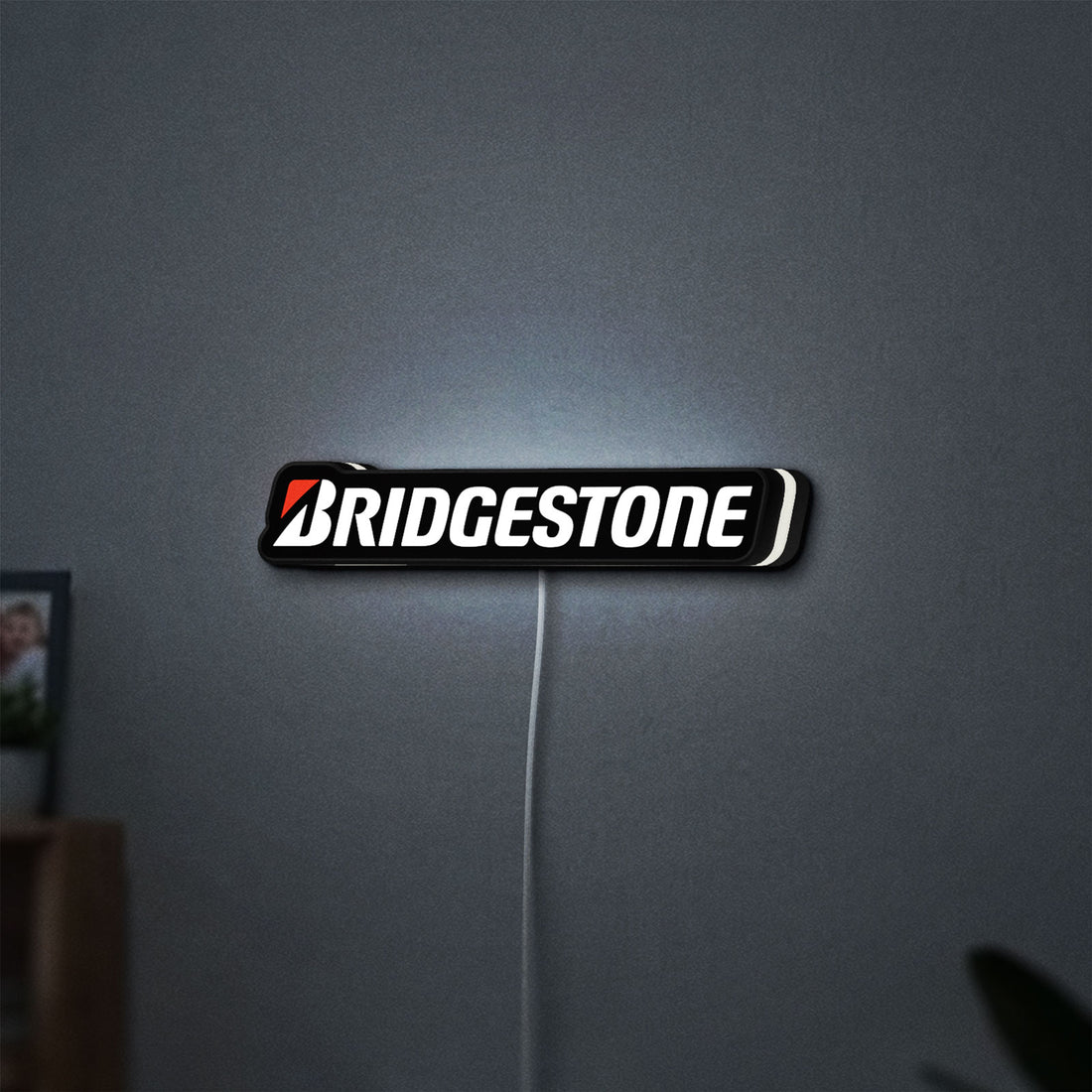 Bridgestone LED lightbox hanging on a wall with white glow