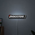 Bridgestone LED lightbox hanging on a wall with white glow