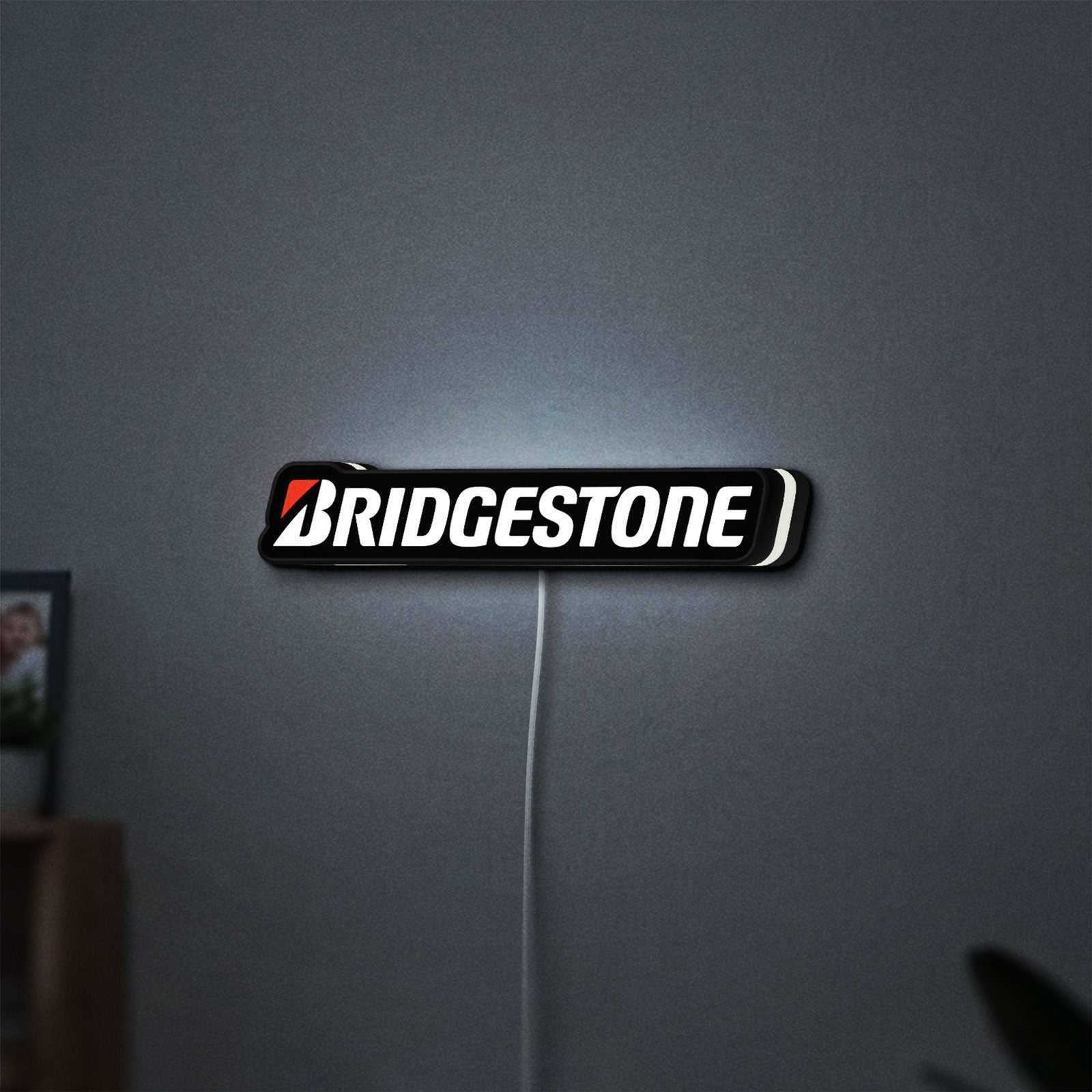 Bridgestone LED lightbox hanging on a wall with white glow