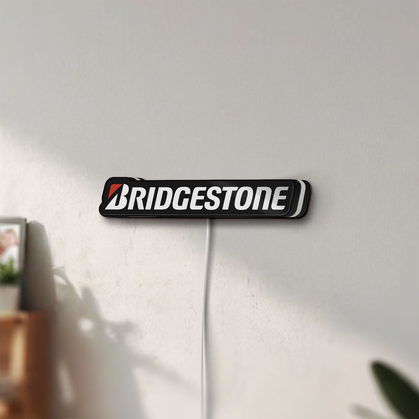 Unlit Bridgestone LED lightbox mounted on a wall in daylight