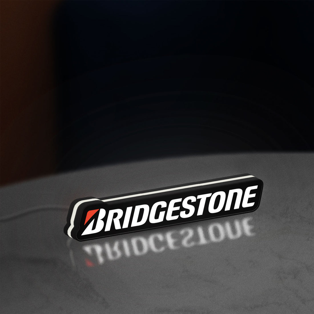 Bridgestone LED lightbox hanging on a wall with white glow