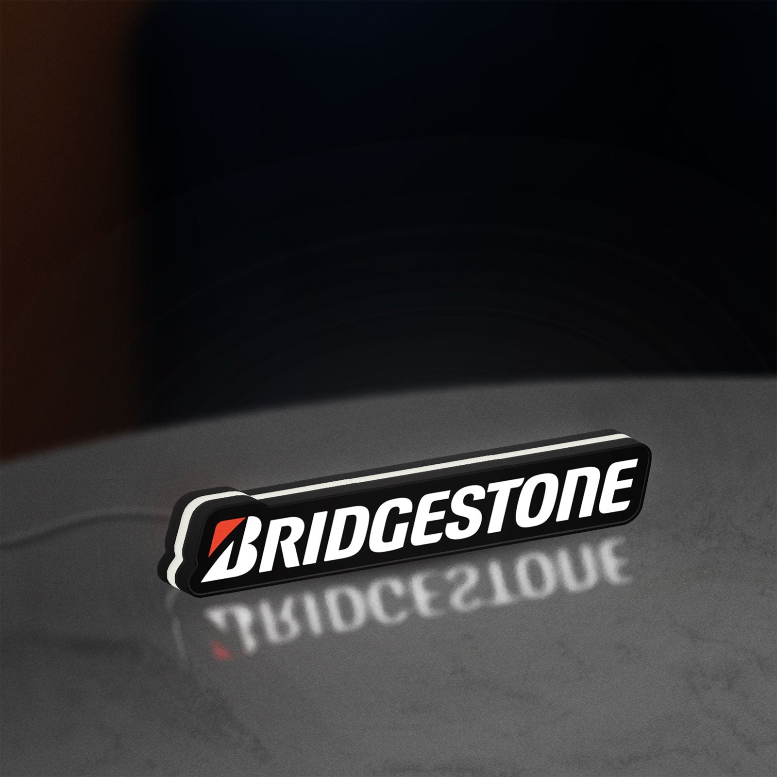 Bridgestone LED lightbox standing on a desk from an angled side view with white glow