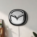 Unlit Mazda LED lightbox mounted on a wall in daylight