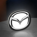 Mazda LED lightbox standing on a desk from an angled side view with white glow