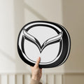 Unlit Mazda LED lightbox held by hand to show size and details