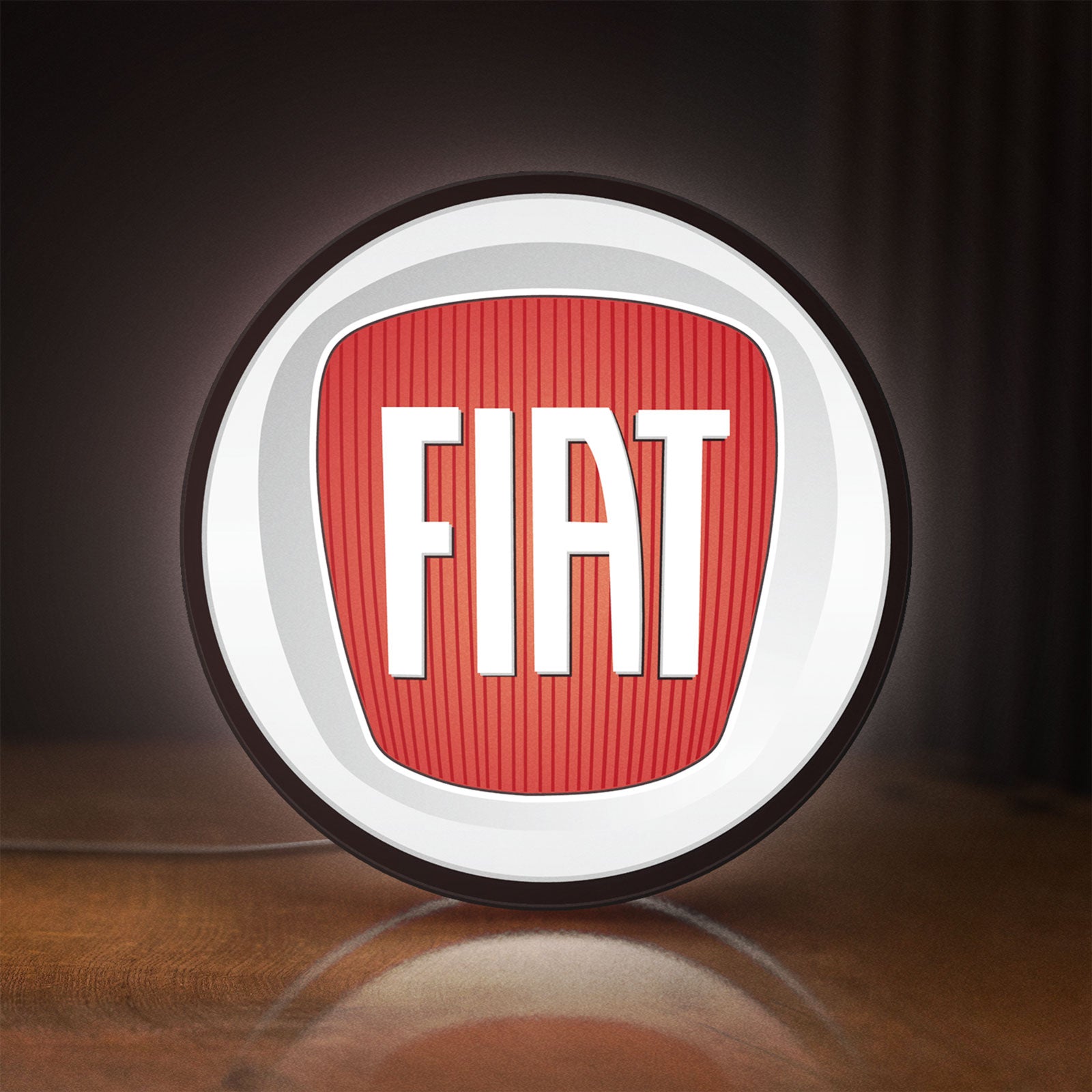 Front view of FIAT 2007 OLD LED lightbox sign glowing on a wooden desk