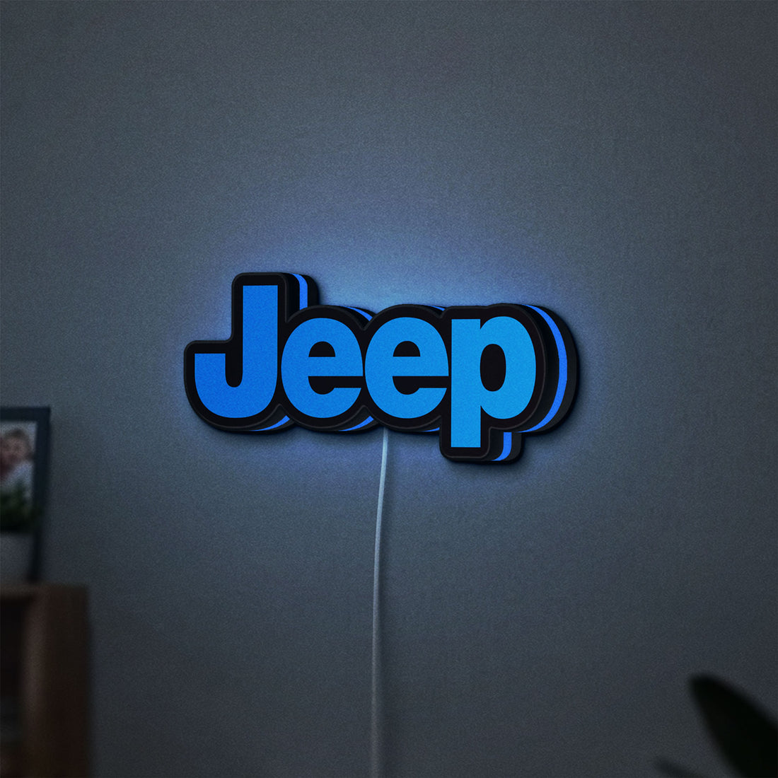 Jeep LED lightbox hanging on a wall with blue glow