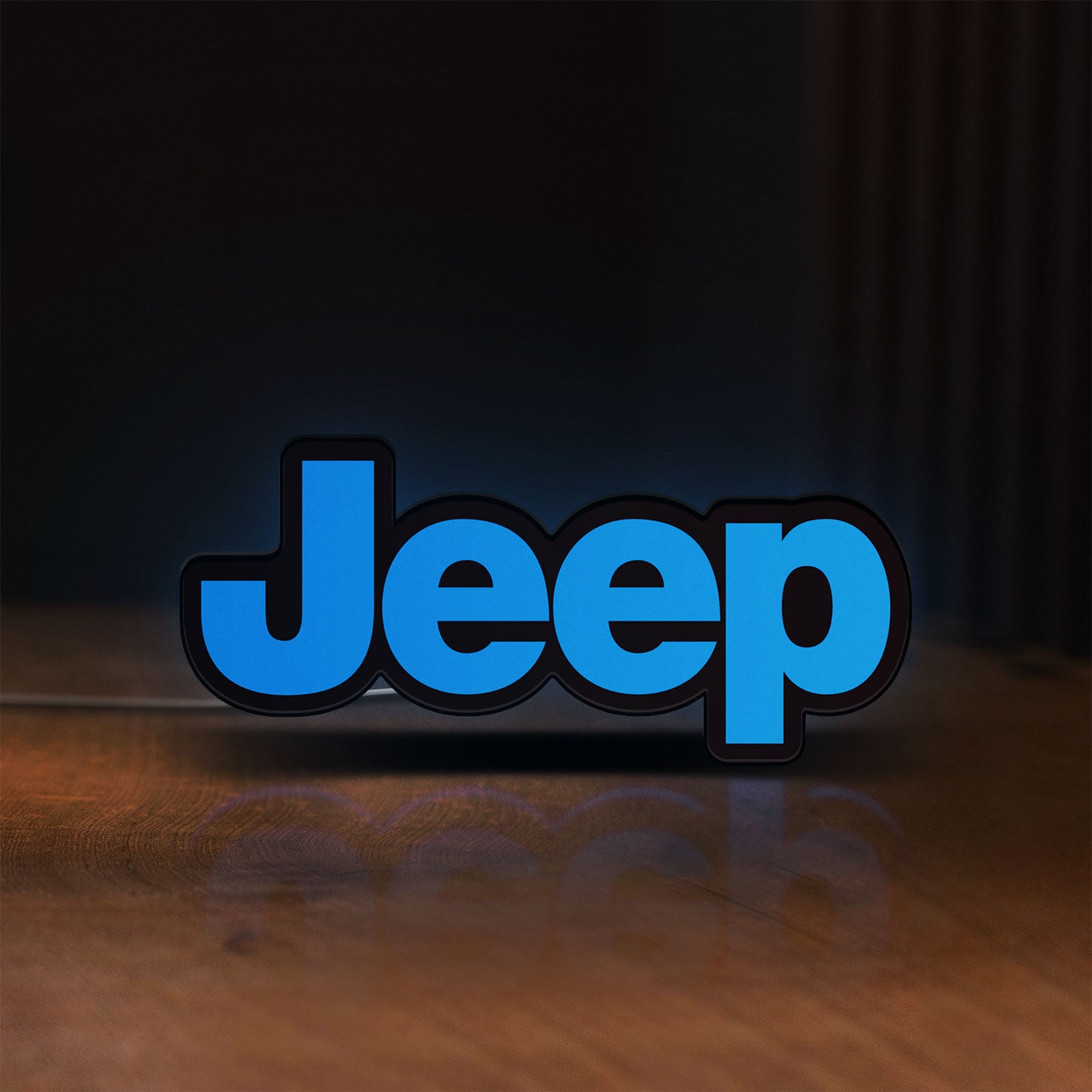 Front view of Jeep LED lightbox sign glowing on a wooden desk