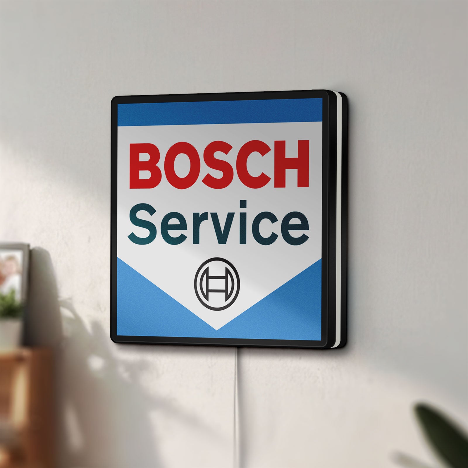 Unlit Bosch Service LED lightbox mounted on a wall in daylight