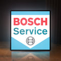Front view of Bosch Service LED lightbox sign glowing on a wooden desk