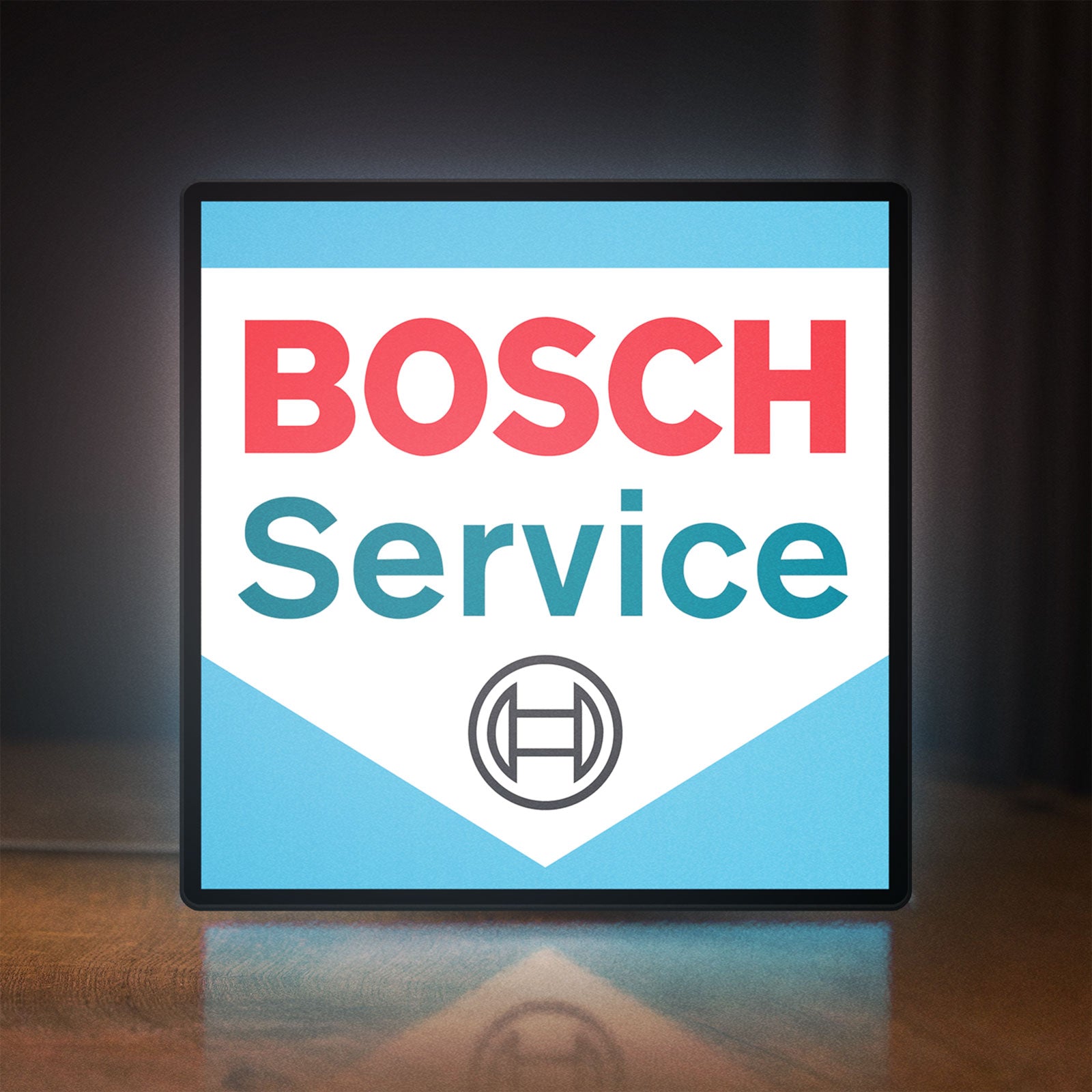 Front view of Bosch Service LED lightbox sign glowing on a wooden desk