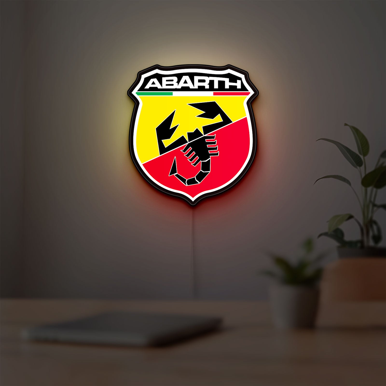 Abarth LED lightbox hanging on a room wall with soft white light