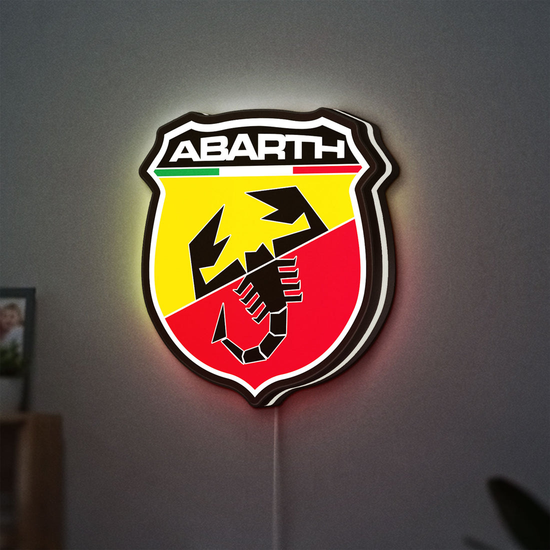 Abarth LED lightbox hanging on a wall with white glow