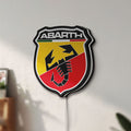 Unlit Abarth LED lightbox mounted on a wall in daylight