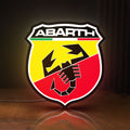 Front view of Abarth LED lightbox sign glowing on a wooden desk
