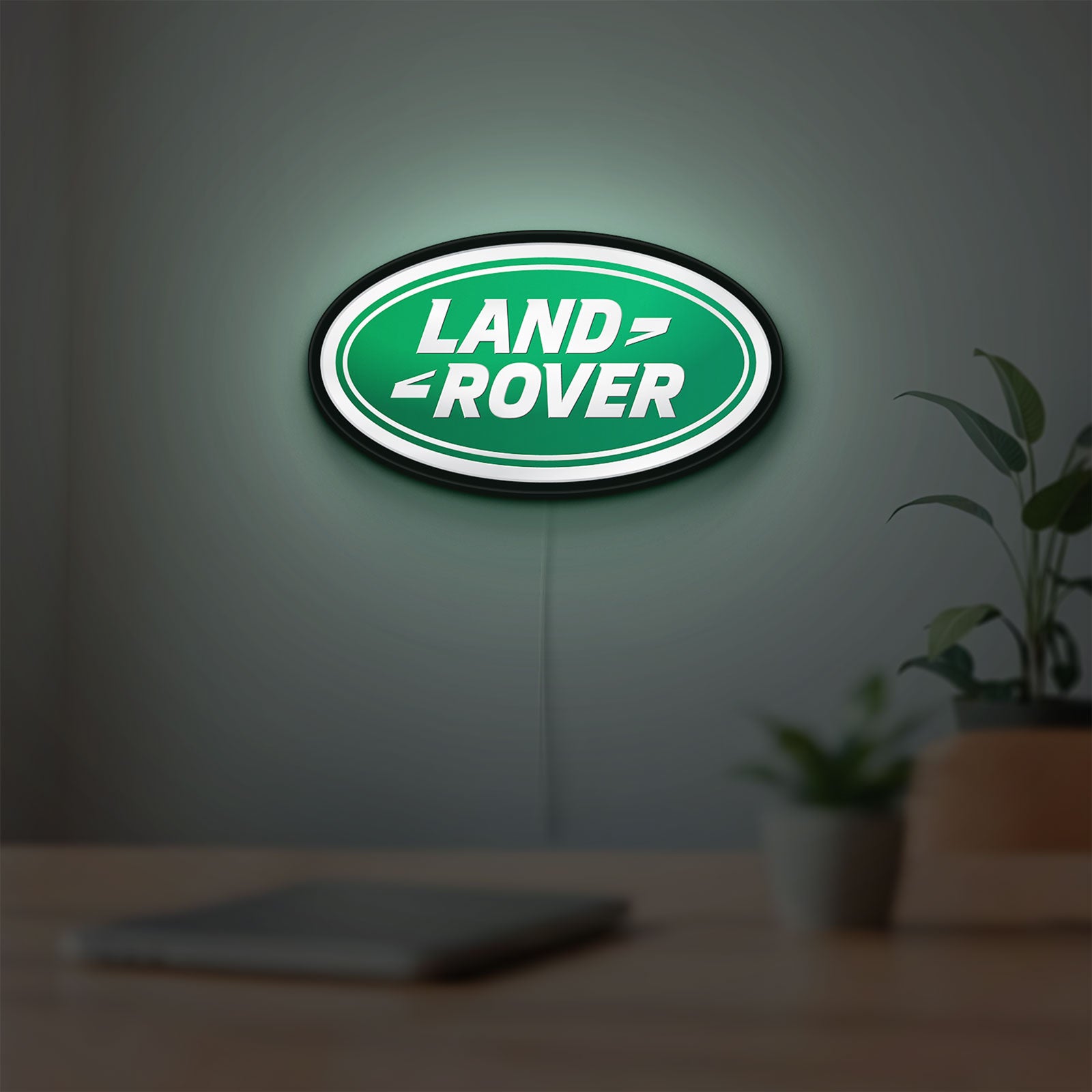 Land Rover LED lightbox hanging on a room wall with soft green light