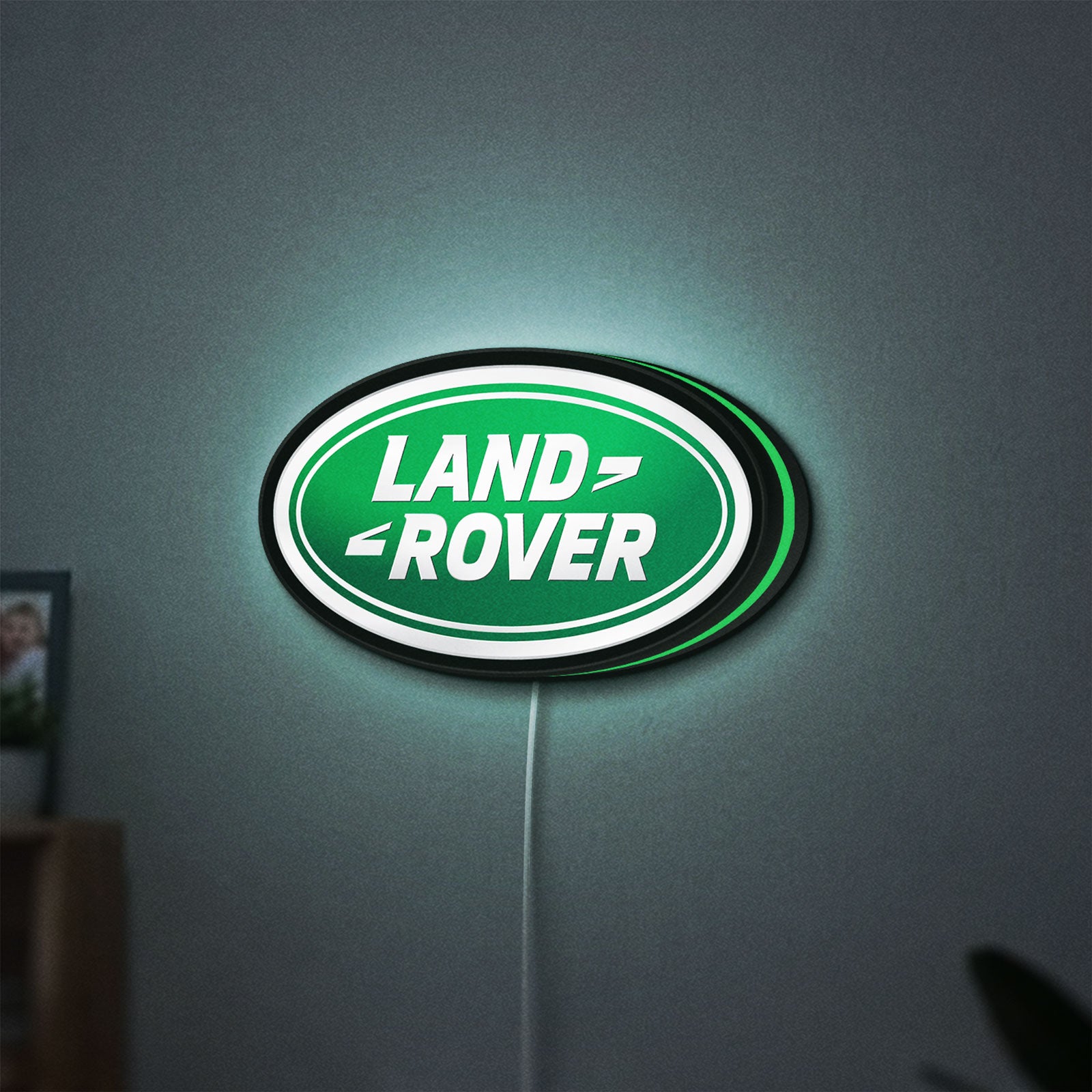 Land Rover LED lightbox hanging on a wall with green glow