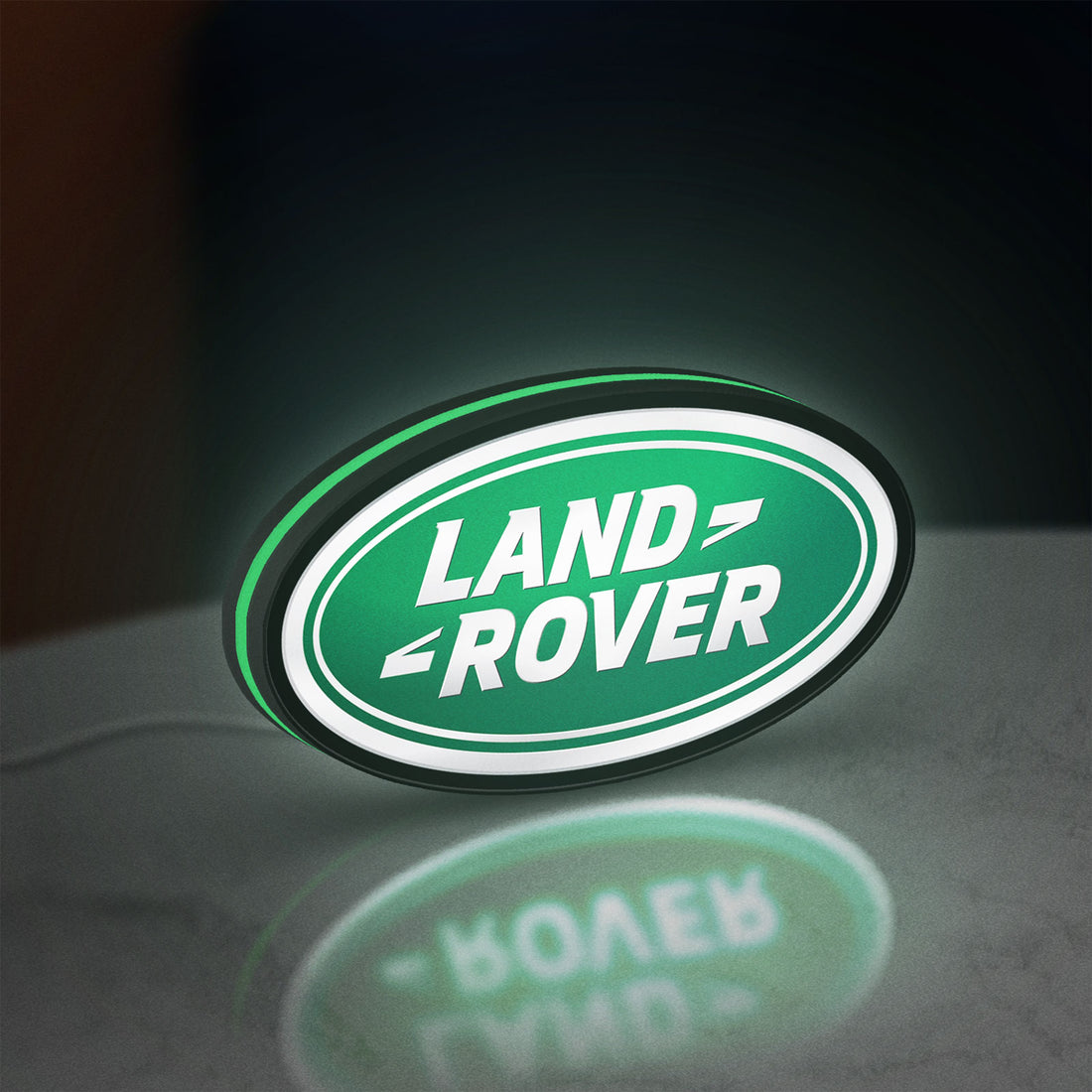 Land Rover LED lightbox hanging on a wall with green glow