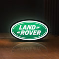 Front view of Land Rover LED lightbox sign glowing on a wooden desk