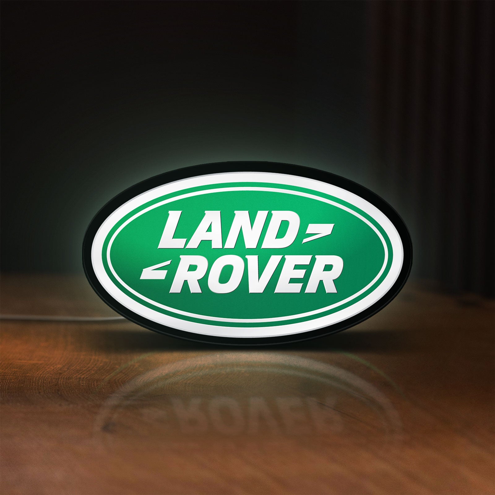 Front view of Land Rover LED lightbox sign glowing on a wooden desk