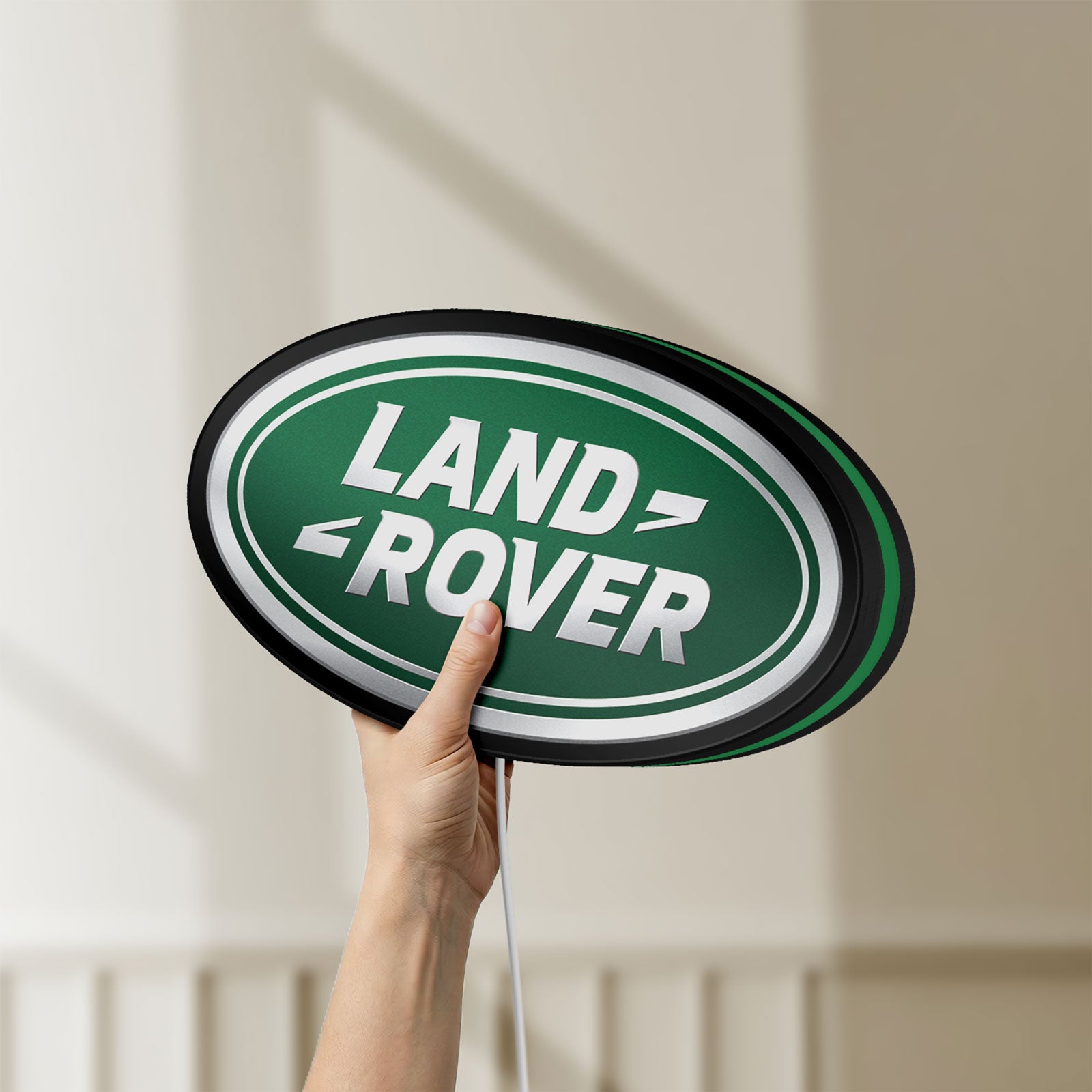 Unlit Land Rover LED lightbox held by hand to show size and details