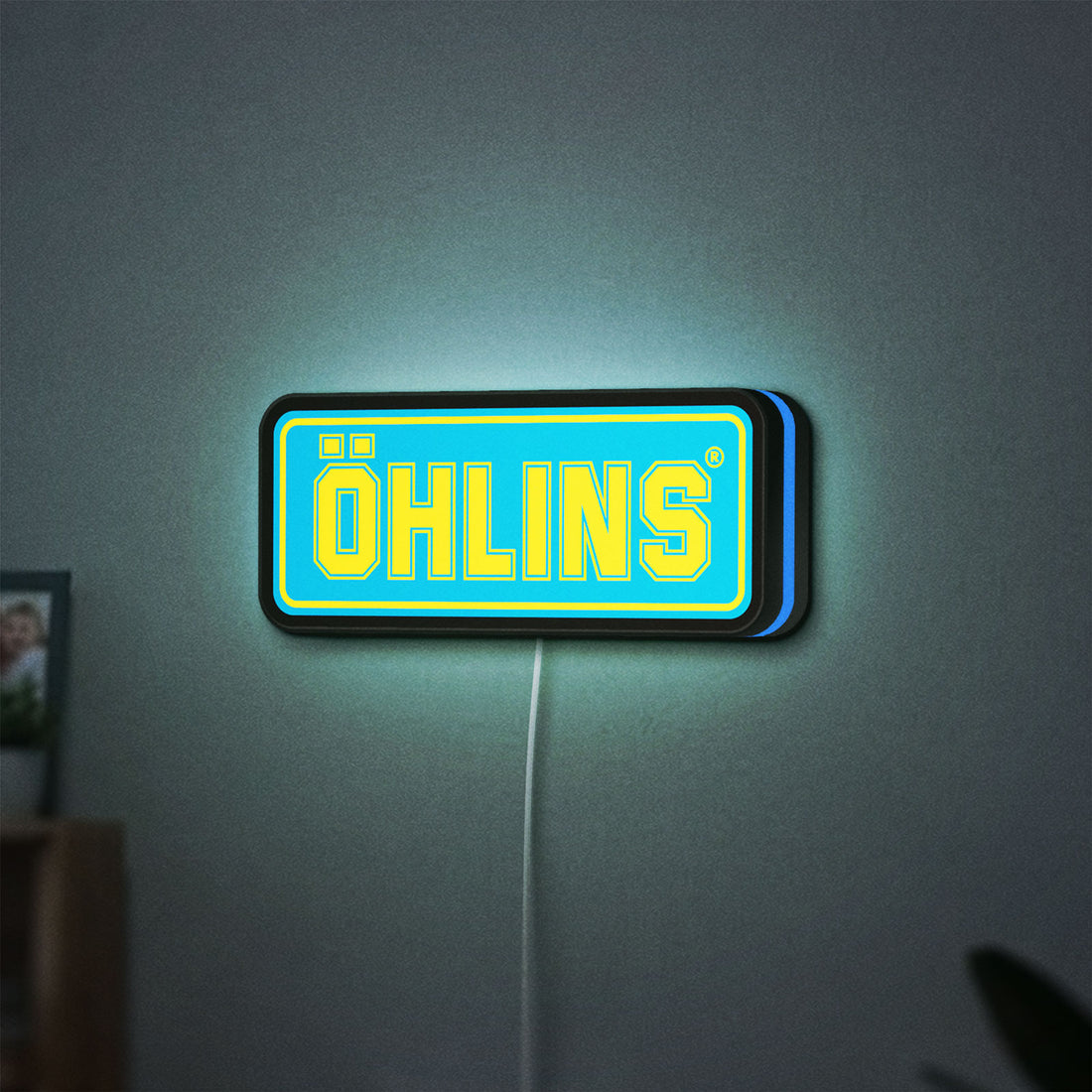 Ohlins LED lightbox hanging on a wall with blue glow