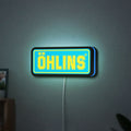 Ohlins LED lightbox hanging on a wall with blue glow