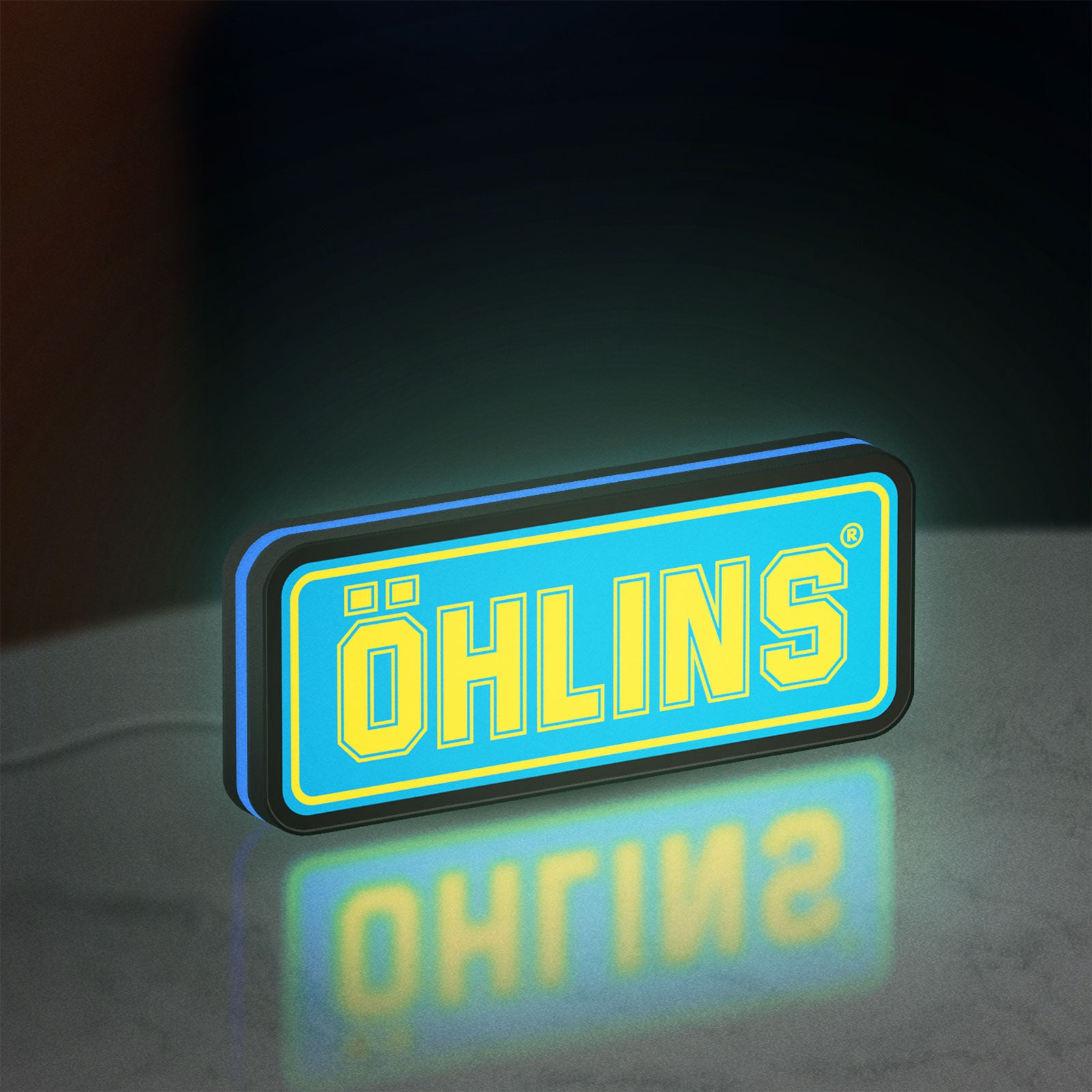 Ohlins LED lightbox standing on a desk from an angled side view with blue glow