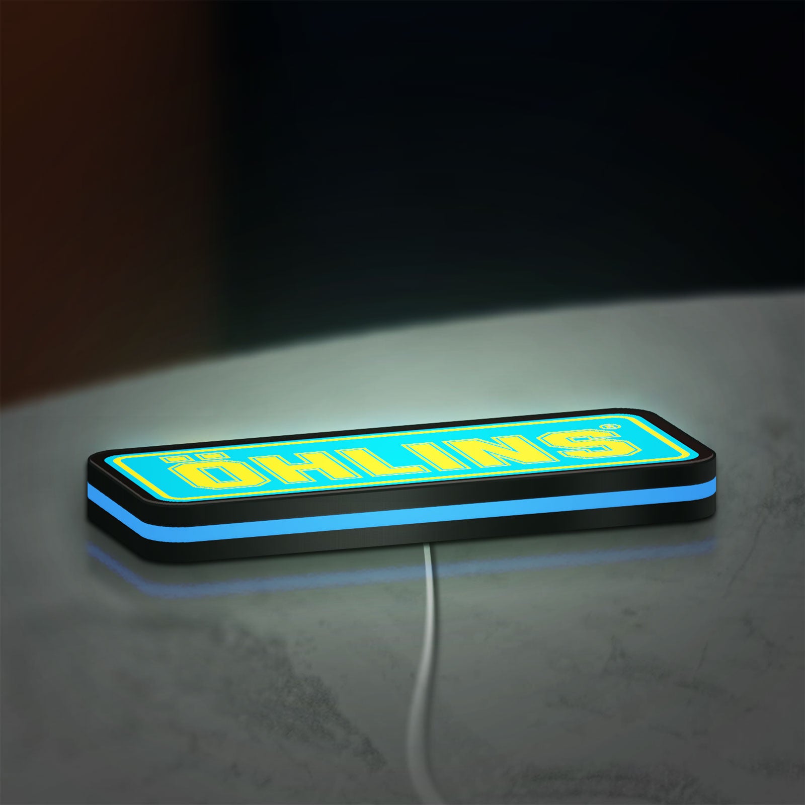 Ohlins LED lightbox lying flat on a desk with blue glow