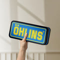 Unlit Ohlins LED lightbox held by hand to show size and details