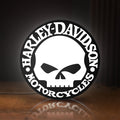 Front view of Harley Davidson Skull LED lightbox sign glowing on a wooden desk
