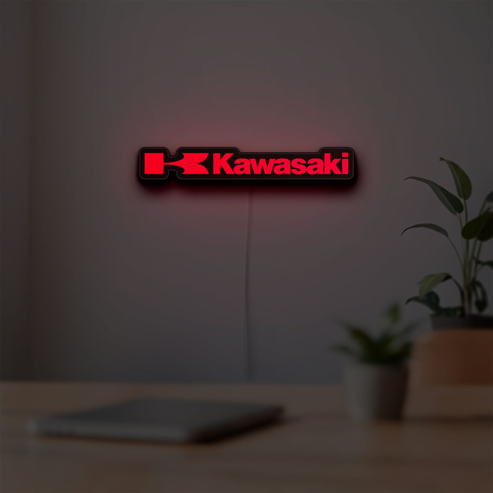 Kawasaki LED lightbox hanging on a room wall with soft red light