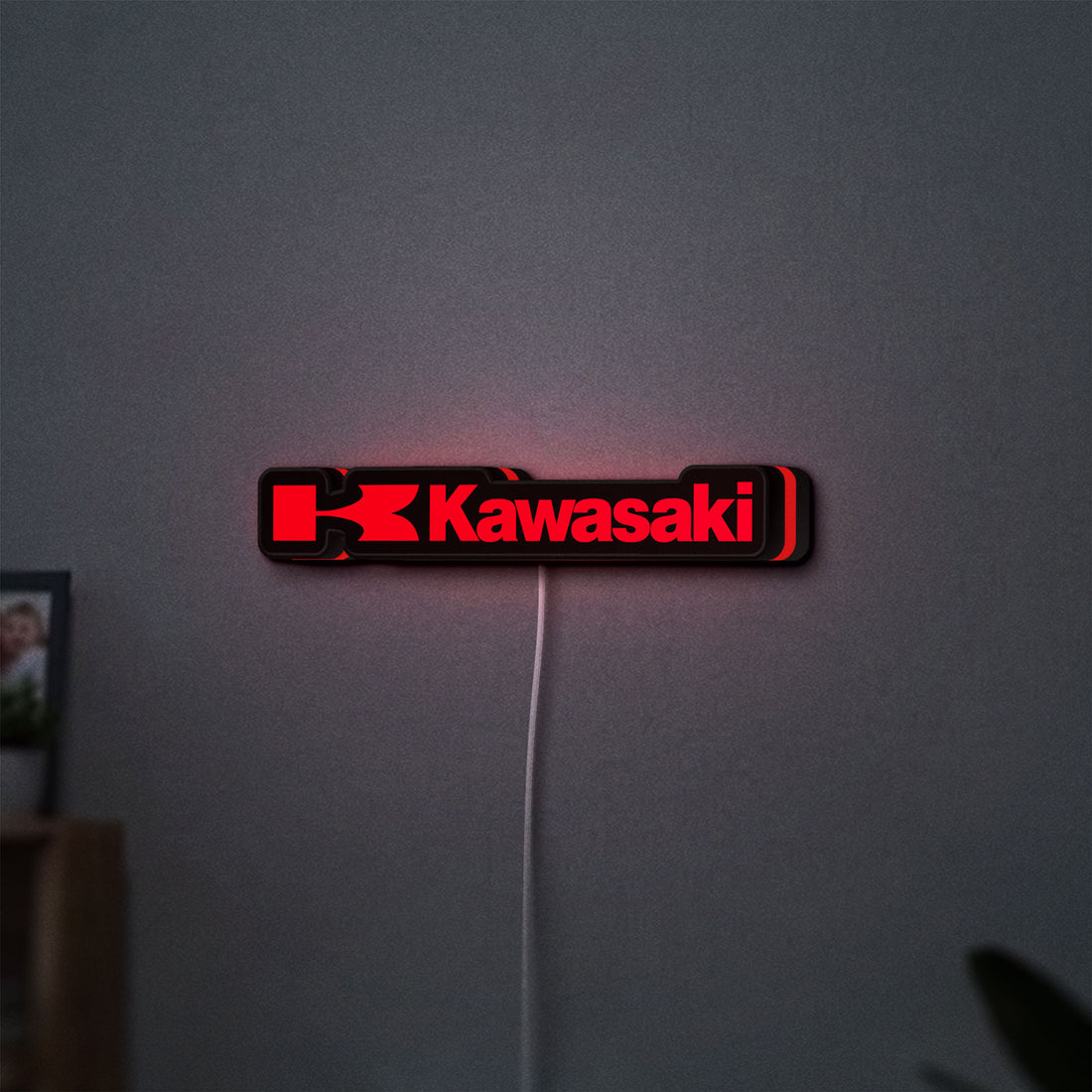 Kawasaki LED lightbox hanging on a wall with red glow