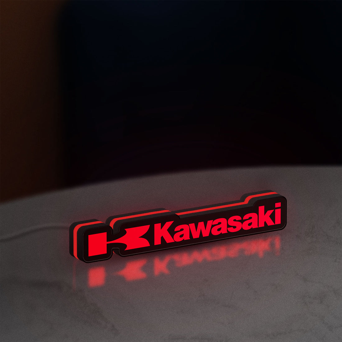 Kawasaki LED lightbox hanging on a wall with red glow