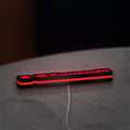Kawasaki LED lightbox lying flat on a desk with red glow
