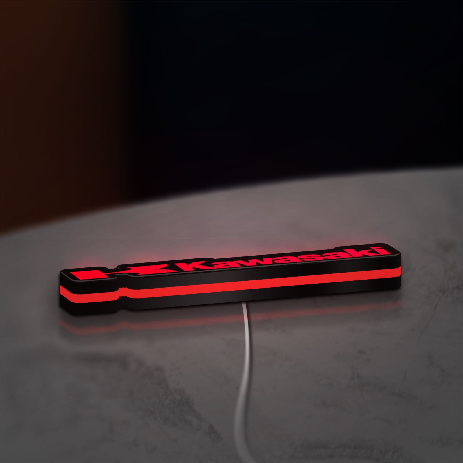 Kawasaki LED lightbox lying flat on a desk with red glow