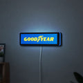 Goodyear LED lightbox hanging on a wall with blue glow
