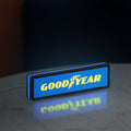 Goodyear LED lightbox standing on a desk from an angled side view with blue glow
