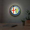 Alfa Romeo LED lightbox hanging on a room wall with soft yellow light