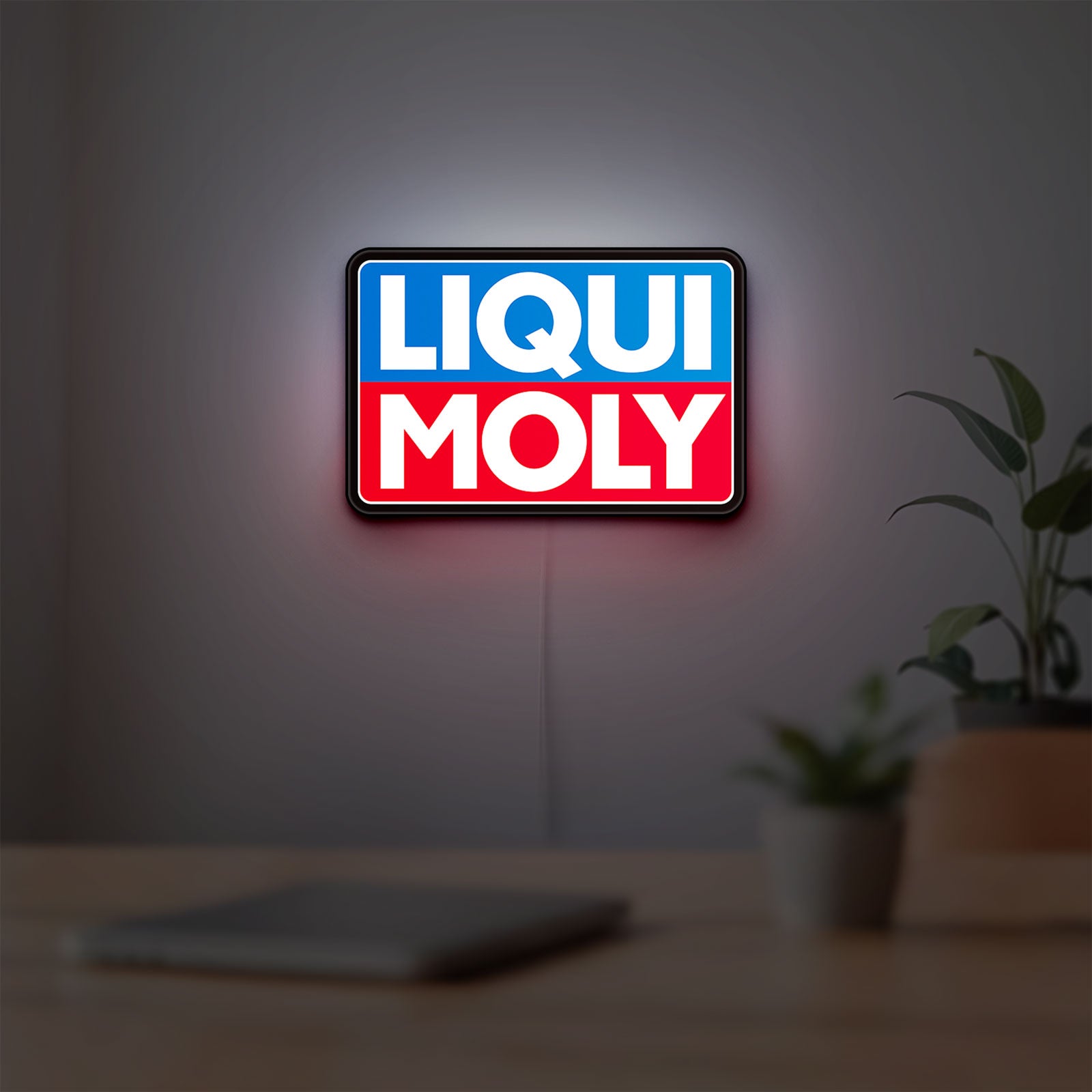 Liqui Moly LED lightbox hanging on a room wall with soft red light
