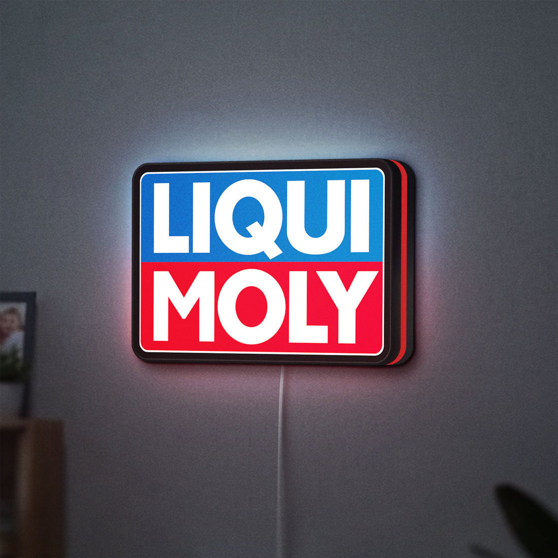 Liqui Moly LED lightbox hanging on a wall with red glow