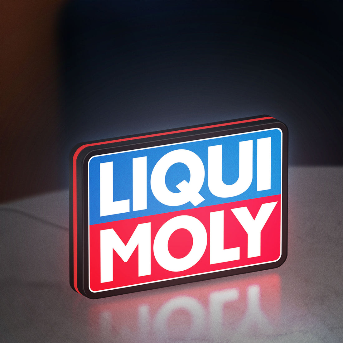 Liqui Moly LED lightbox hanging on a wall with red glow