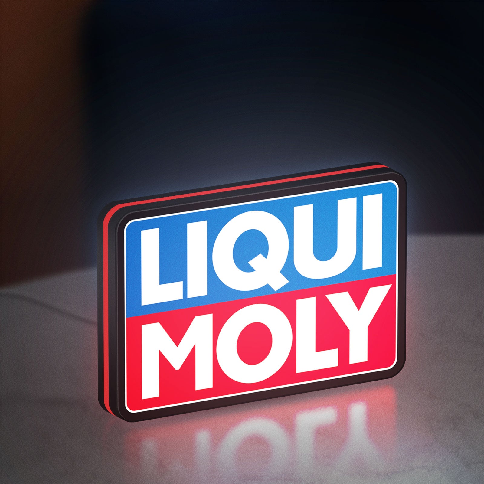 Liqui Moly LED lightbox standing on a desk from an angled side view with red glow