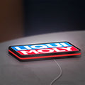 Liqui Moly LED lightbox lying flat on a desk with red glow