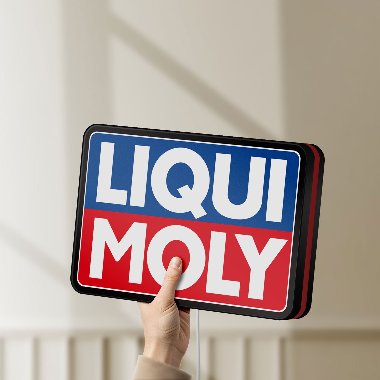 Unlit Liqui Moly LED lightbox held by hand to show size and details