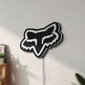 Unlit Fox Head LED lightbox mounted on a wall in daylight