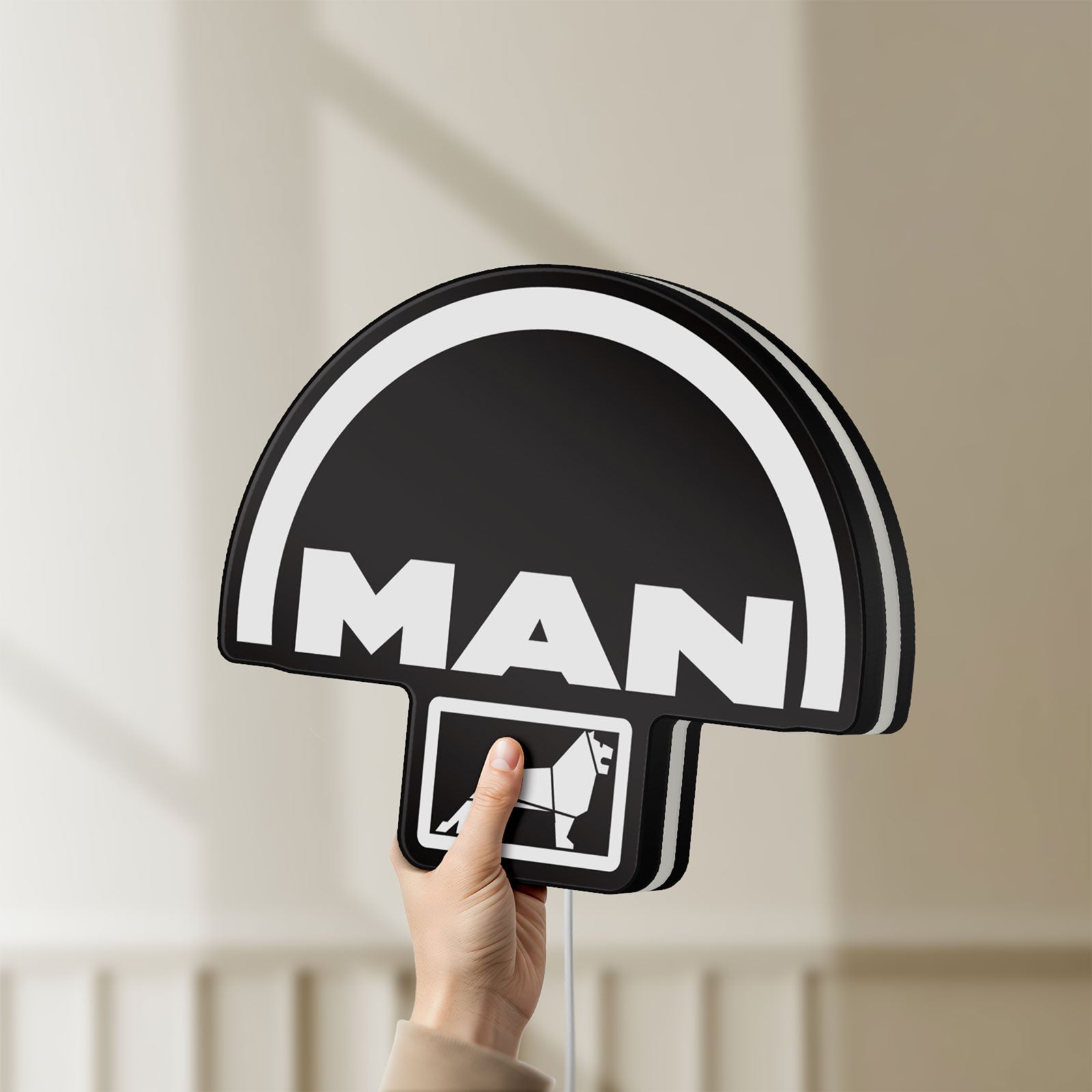 Unlit MAN Trucks LED lightbox held by hand to show size and details